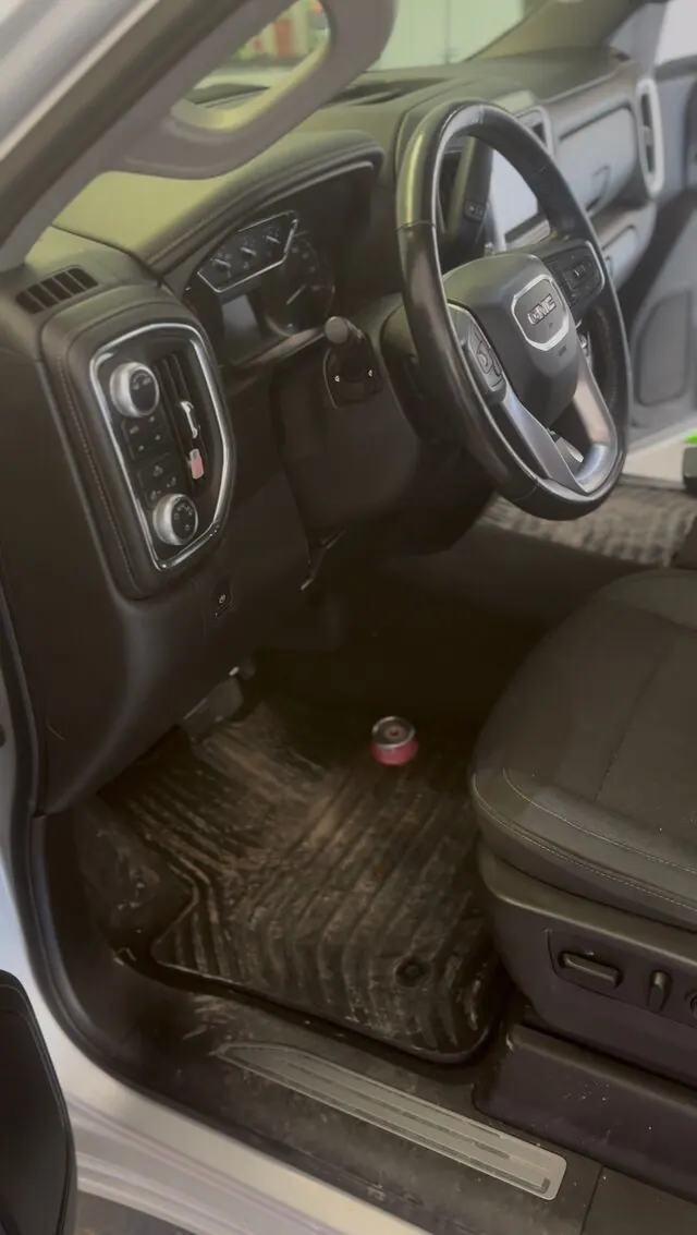 GMC cabin before: dirty mats and dusty console